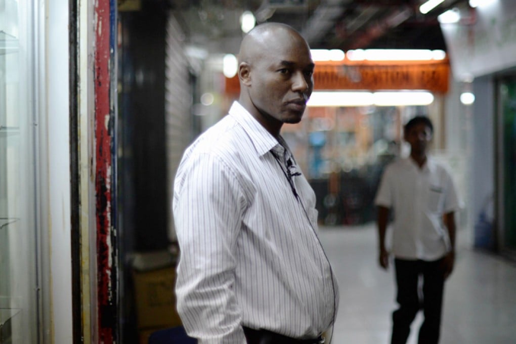 39-year-old trader Ali Diallo from Guinea, who sells Chinese electronics to retailers across Africa, stands outside his shop in Chungking Mansions in Hong Kong. Photo: AFP