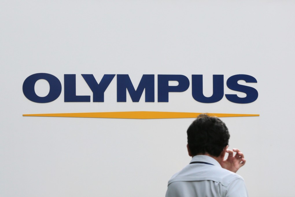 Ex-banker admits role in Olympus fraud case