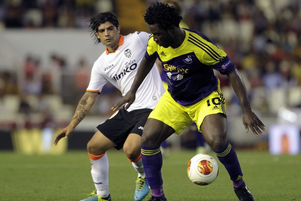 Swansea City's Wilfried Bony (R) and Valencia's Ever Banega fight for the ball during their Europa League soccer match at the Mestalla stadium in Valencia. Photo: Reuters