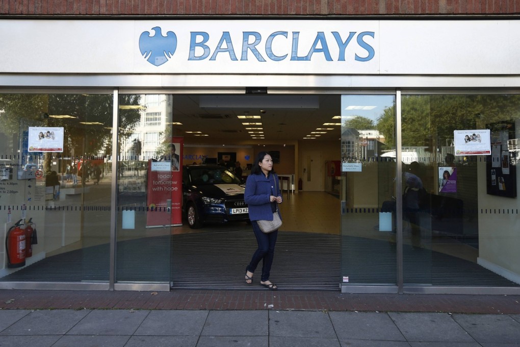 A woman leaves the Swiss Cottage branch of Barclays in London. Eight men have been arrested over the alleged theft of US$2.1 million by taking control of a Barclays branch computer system. Photo: Reuters