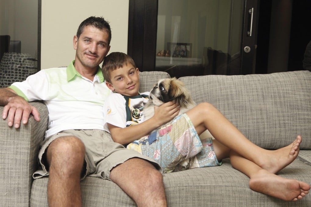 Joost van der Westhuizen at home in Johannesburg with his son Jordan and dog Buddy earlier this year. Photo: Getty Images