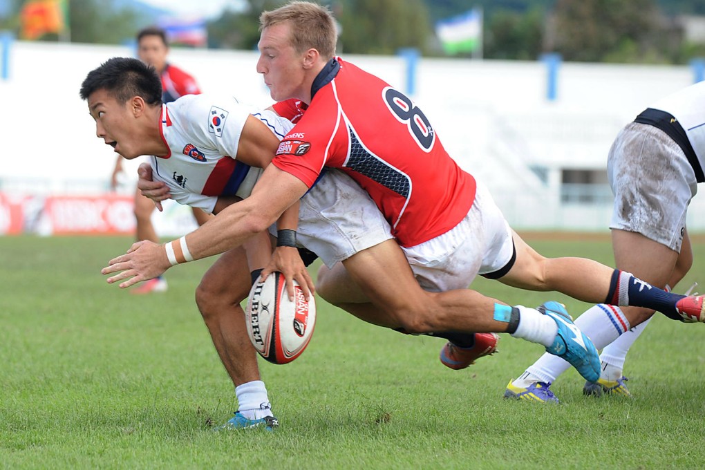 Alex McQueen puts in a tackle in the semis against South Korea.