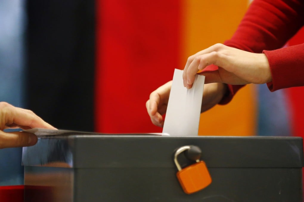 A voter casts his ballot at a polling station during the German general election, in Berlin. Photo: Reuters