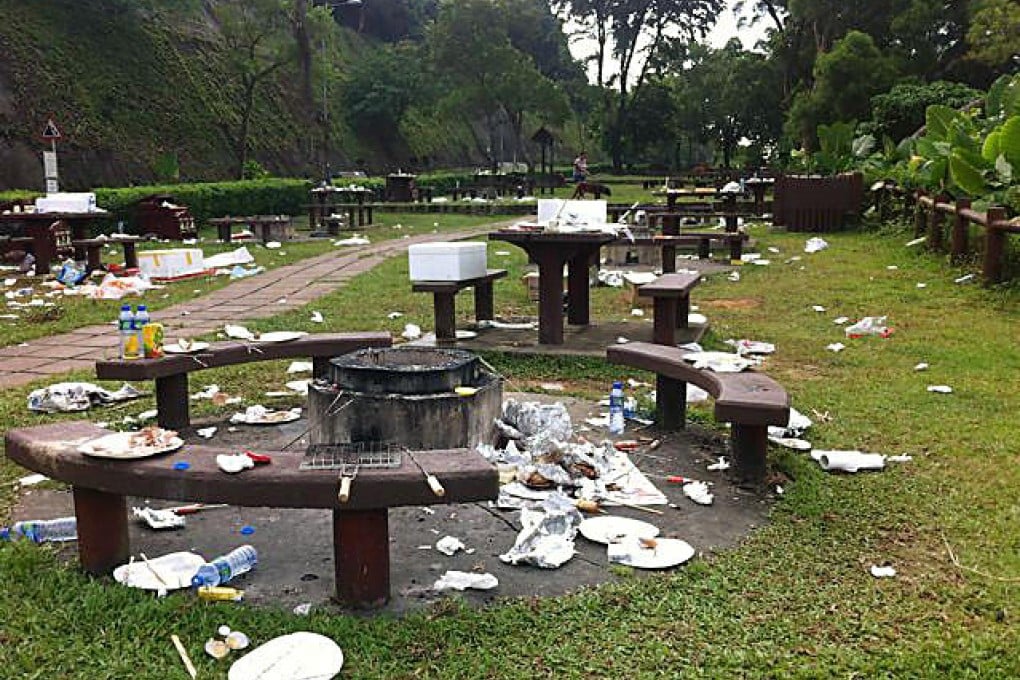 Litter is strewn across a picnic site while bins lie empty.