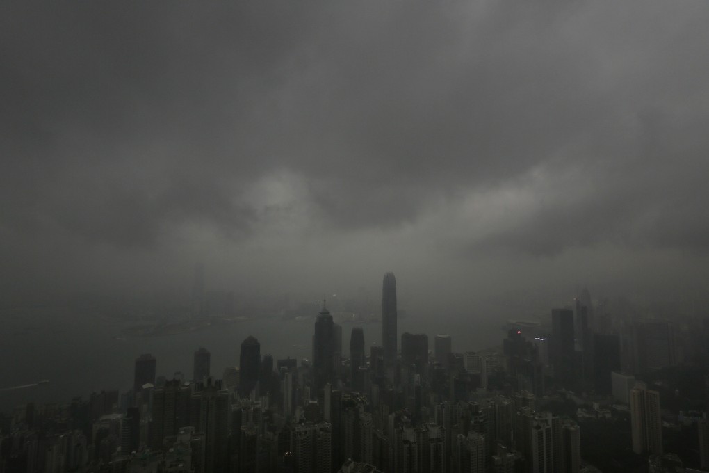 Dark clouds hang low over Hong Kong's Victoria Habour. Photo: AP