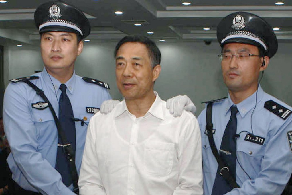 Bo Xilai, handcuffed and flanked by guards, after the guilty verdict was announced. Photo: Reuters
