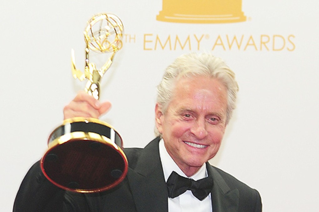 Michael Douglas celebrates winning Best Actor in 'Behind the Candelabra' on Sunday in the press room during the 65th Annual Primetime Emmy Awards in Los Angeles, California. Photo: AFP