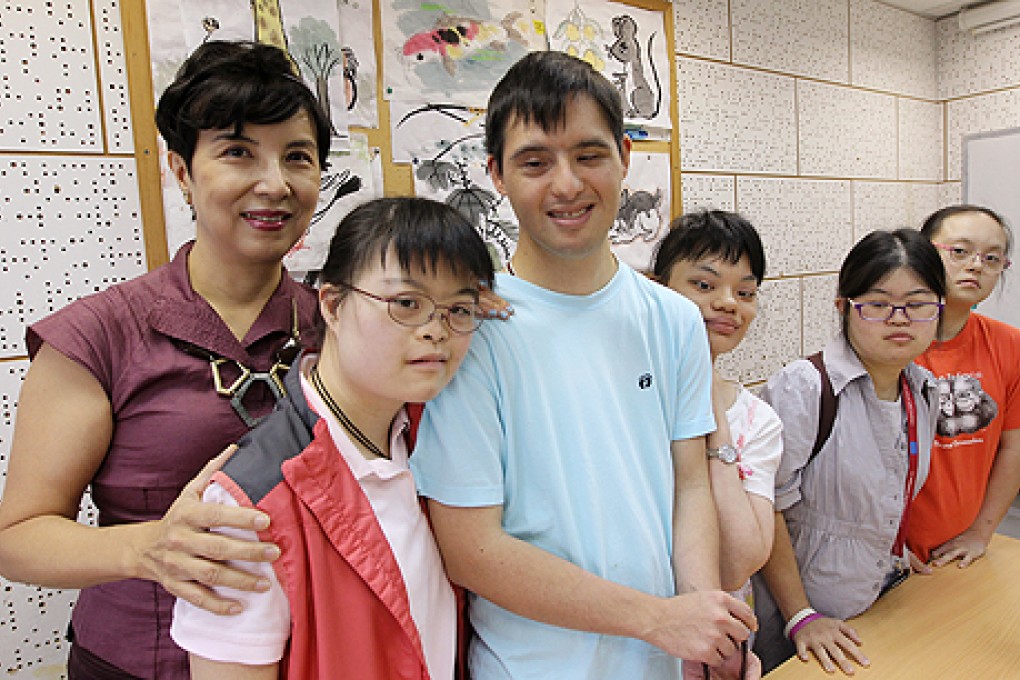 Sonja Shih Chan Seung-yan with some of the young adults with mental disabilities she volunteers to help at the Tung Wah Building in Wan Chai. Photo: Edward Wong