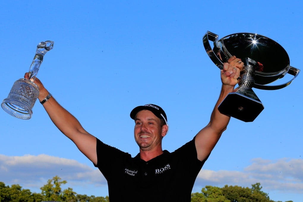 Henrik Stenson of Sweden hoists the Tour Championship trophy and the FedEx Cup after winning the play-offs. Photo: AFP