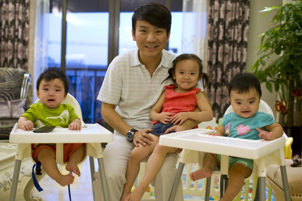 Businessman Tony Jiang poses with his three children, all born in California to an American surrogate he calls 'my Amanda'. Photo: Reuters