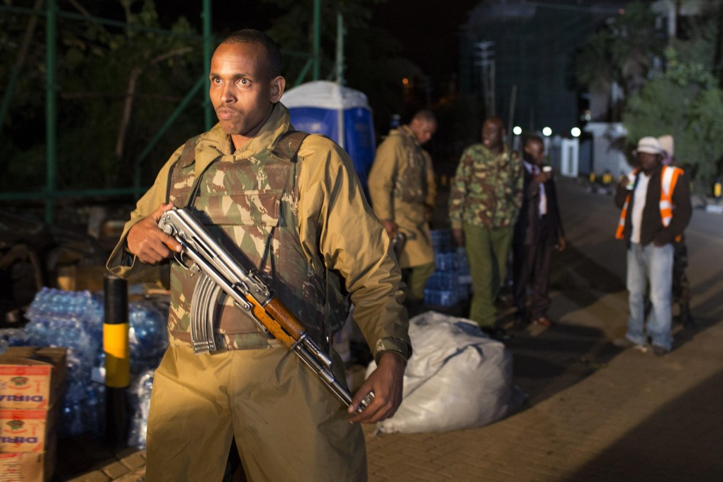 A police officer walks towards the edge of a security perimeter put into place a distance from the Westgate Shopping Centre in Nairobi. Photo: Reuters