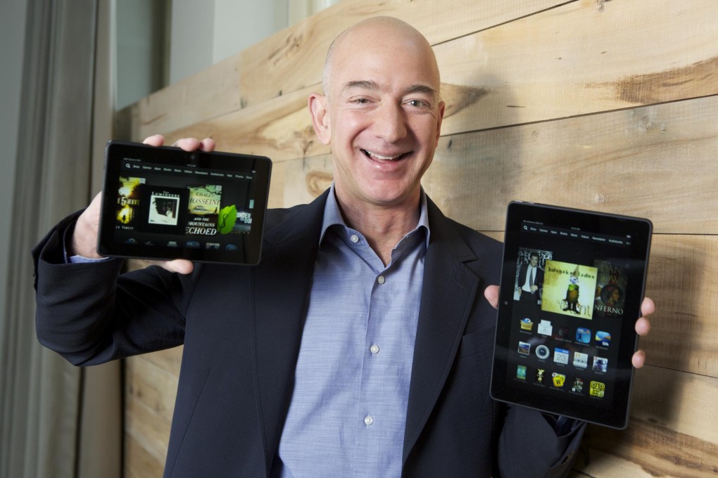 Jeff Bezos holds up the new range of Kindles. Photo: AP