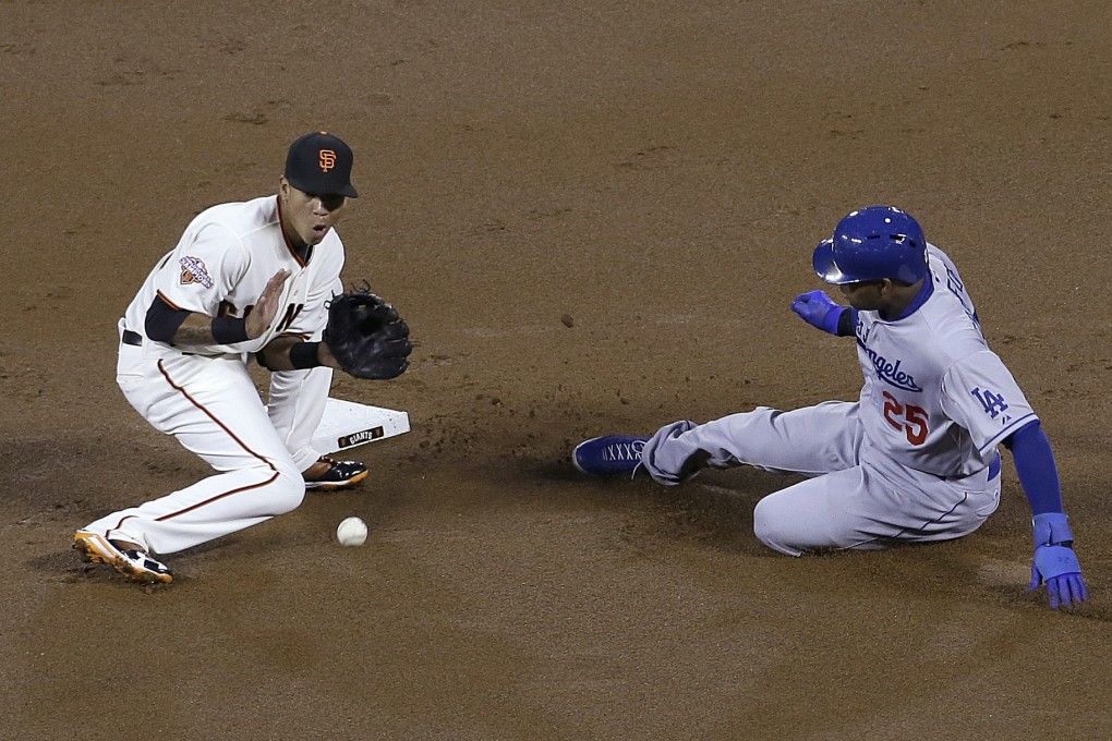 Los Angeles Dodgers' Carl Crawford (right) steals second base next to San Francisco Giants shortstop Ehire Adrianza during the first inning of a baseball game in San Francisco on Tuesday. Photo: AP