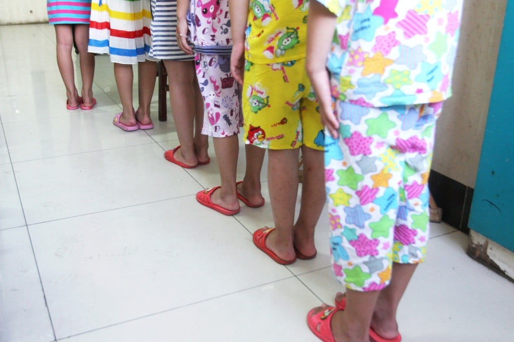Sex abuse victims, aged eight and nine, re-enact how they say their teacher made them queue outside his office to be abused in Jiujiang, Jiangxi province. Photo: Mimi Lau