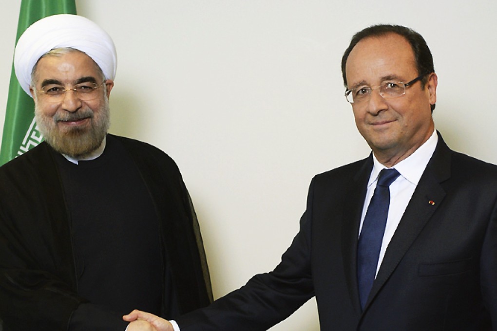 Francois Hollande shakes hands with Hassan Rohani on Tuesday. Photo: AFP