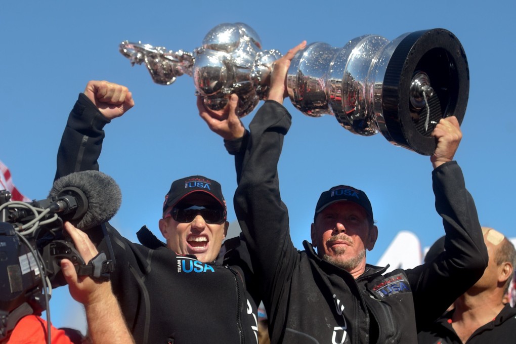 Oracle Team USA skipper Jimmy Spithill (left) and Oracle Corp. CEO Larry Ellison hoist the America's Cup trophy after beating Emirates Team New Zealand in San Francisco. Photo: AFP