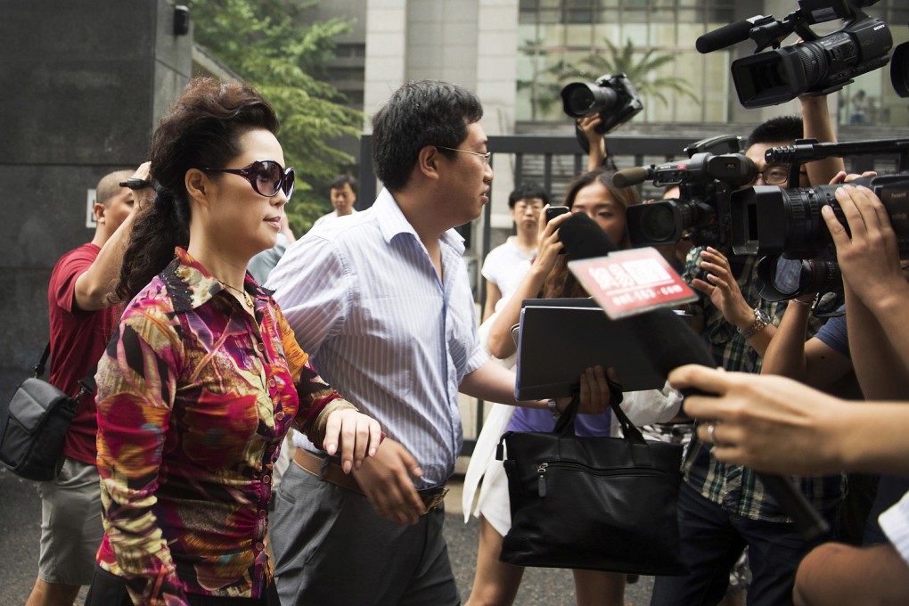 Meng Ge, left, the mother of Li Tianyi, is mobbed by journalists as she attends her son's trial at a court in Beijing in August. Photo: AP