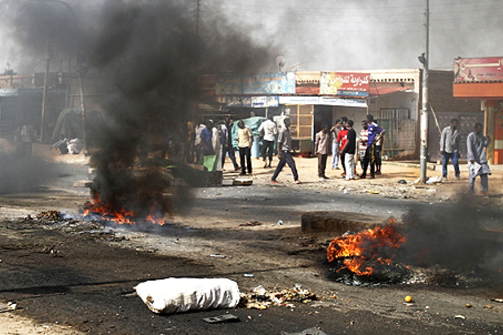 Protesters burn tires and close the highway to northern cities amid a wave of unrest over the lifting of fuel subsidies by the Sudanese government, in Kadro, on Wednesday. Photo: AP