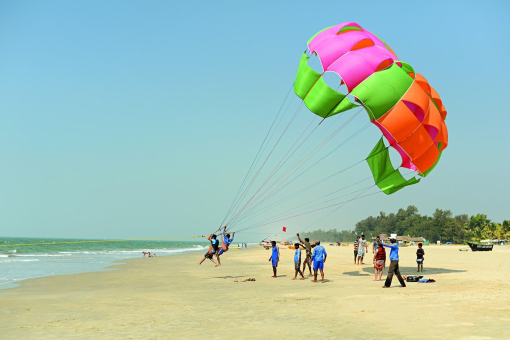 A plucky pair parasail from the golden beach.