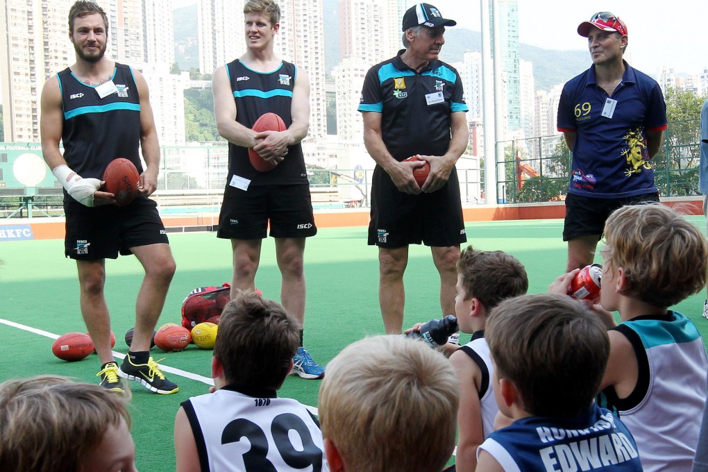 Port Adelaide players Tom Logan (left) and Tom Jones, with club legend Russell Ebert and HKFC's Warwick Kendall at a coaching clinic in Happy Valley. Photo: Edmond So