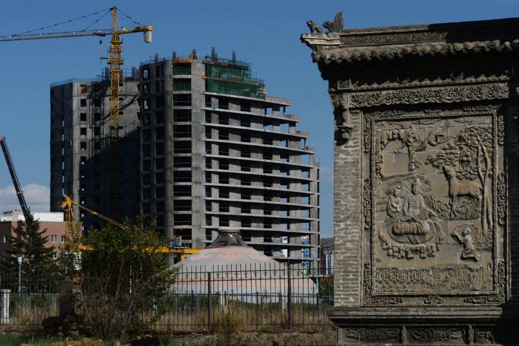A new hotel stands near an ancient temple in Ulan Bator. Mongolia is aiming for greater connectivity with the outside world. Photo: AFP