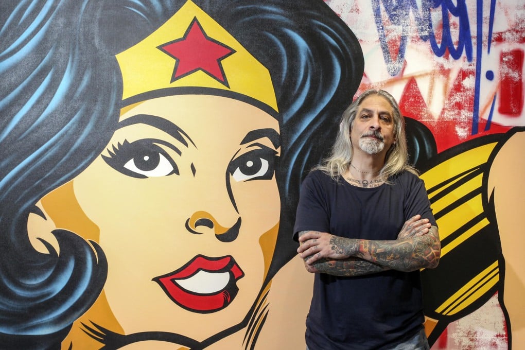 Richard Mirando with his stencil and spray paint on canvas Wonder Woman at Opera Gallery.