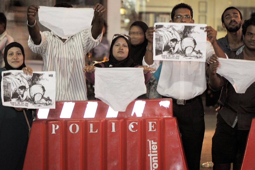 Maldivian activists wave underwear and cartoons as they stage a protest in Male. Photo: AFP