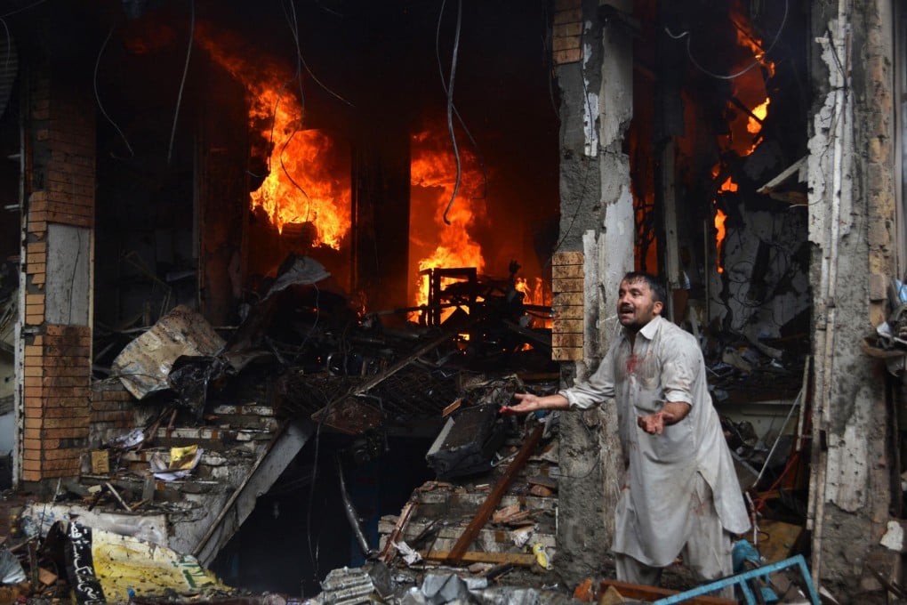 A man amid the destruction of the car bomb. Photo: Xinhua
