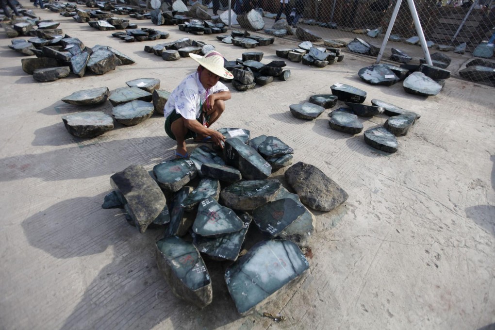 This is not where the real profits are: A trader looks at jade at an emporium in Myanmar's capital Naypyidaw. Photo: Reuters