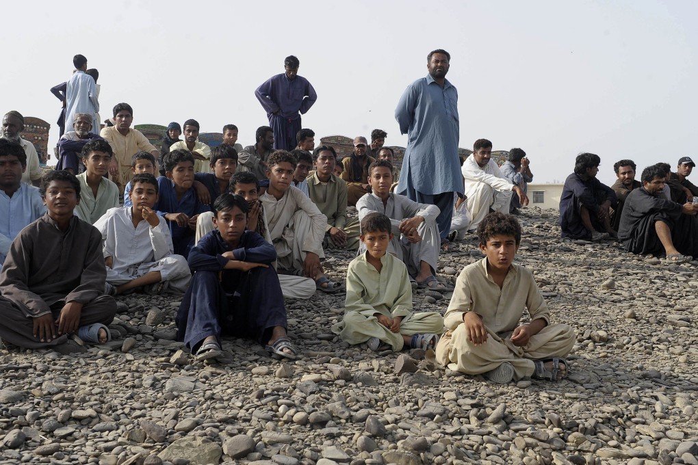 Pakistani earthquake survivors gather at a relief distribution point in the earthquake-devastated district of Awaran. Photo: AFP