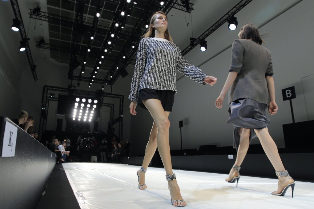 Models walk onto a catwalk in Paris. Photo: Reuters