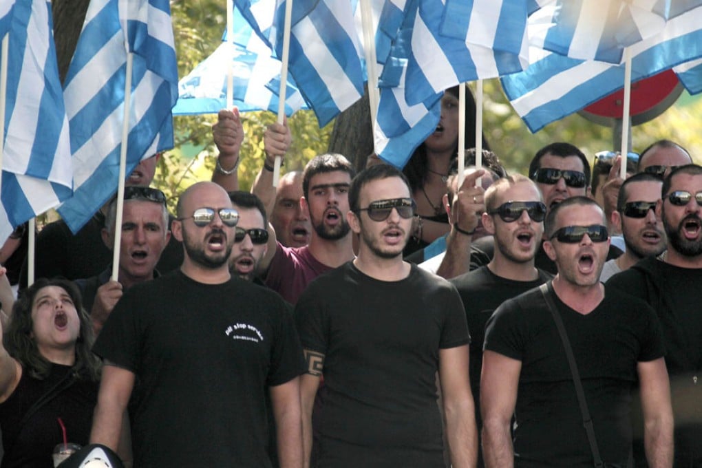 Supporters of the Golden Dawn party gather in front of the Athens police headquarters to protest over the arrest of their leader. Photo: EPA