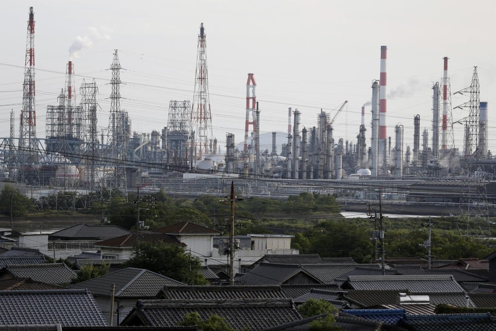 An industrial complex towers over houses in Japan, where the manufacturing sector is expected to have grown by 5.2 per cent year on year last month. Photo: Bloomberg