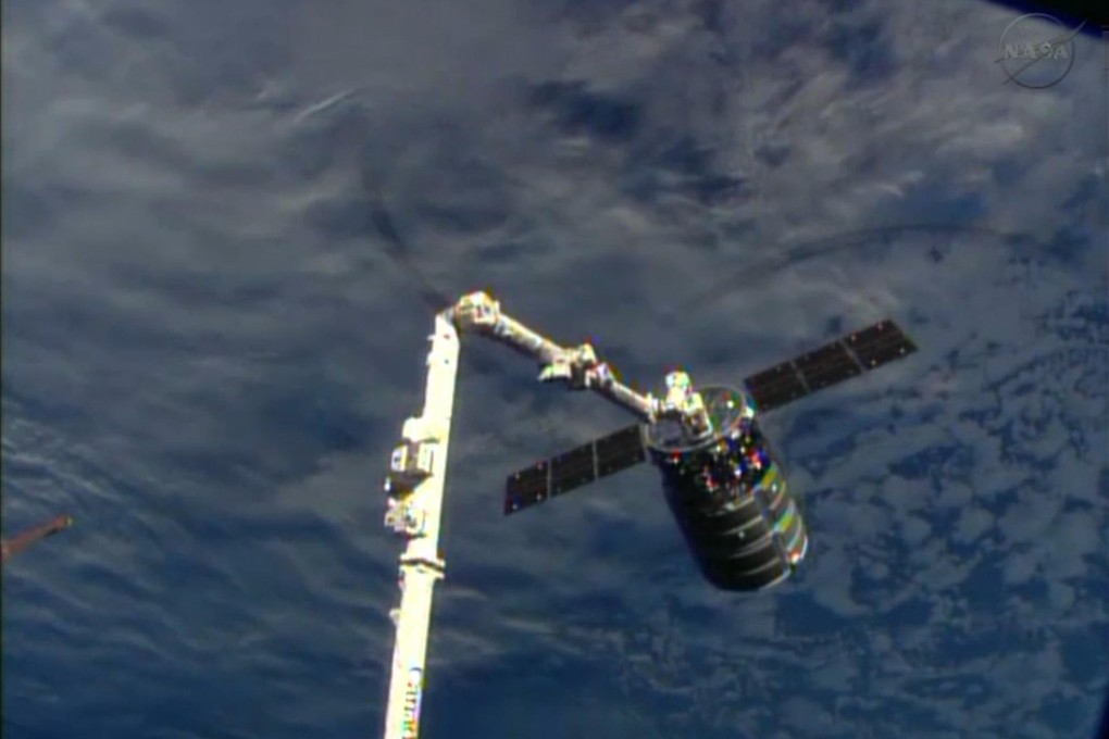 Cygnus attached to the space station's arm. Photo: AP