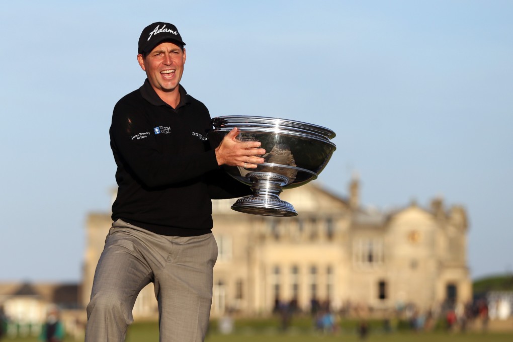 England’s David Howell holds the Alfred Dunhill Links Championship trophy after his play-off win at St Andrews. Photo: AFP