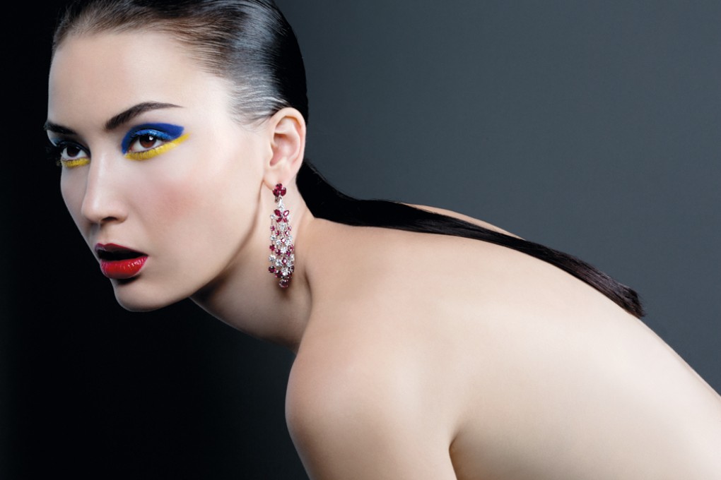 Saida wears Eye M.A.C Pigment in Marine Ultra (HK$195), Lancôme Blush Rose Désir (HK$360), Shiseido Lacquer Rouge in Sanguine (HK$220), and diamond and ruby earrings by Graff.