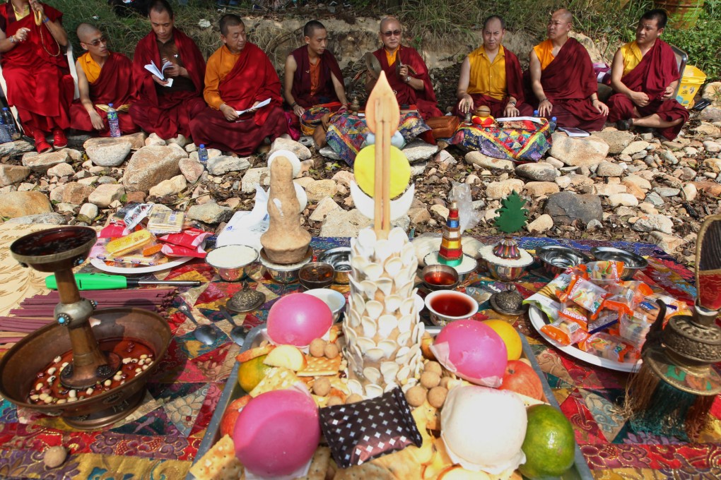 Followers of Tibetan Buddhism attend a religious ceremony on Lamma Island on the first anniversary of the ferry tragedy. Monks sit in front of offerings. Photo: Felix Wong