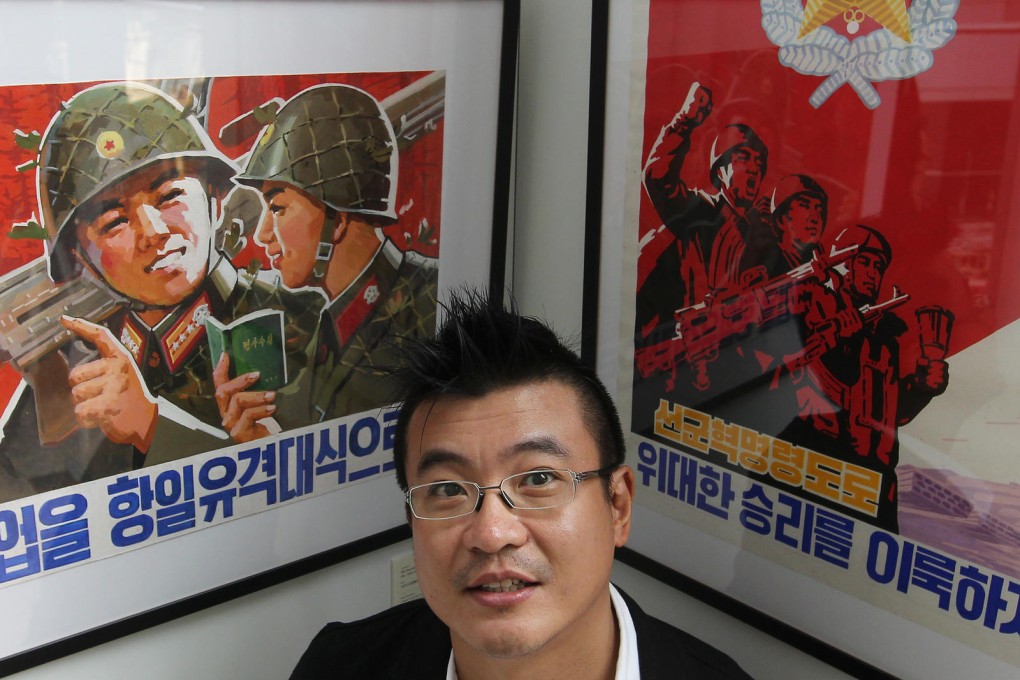 Eric Wong and his display of North Korean propaganda posters at Taikoo Place. Photo: May Tse