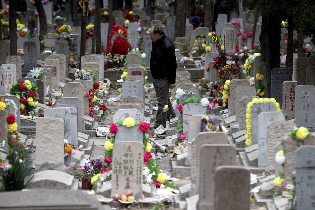 A Chinese man looks for his family grave at the Babaoshan cemetery during the Qingming Festival in Beijing. Photo: AP