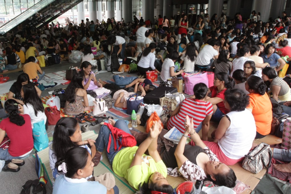 Domestic helpers gather in Central to enjoy their day off.