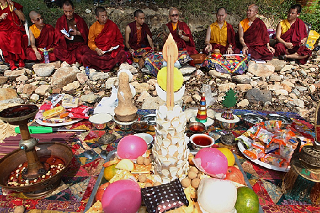 Buddhist monks perform prayer rituals on Lamma Island on Tuesday  for the victims of the ferry disaster that occurred exactly one year ago. Photo: Felix Wong