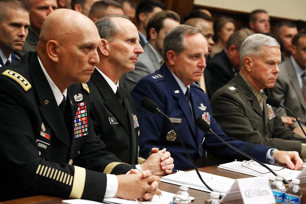 Military leaders including General James Amos, far right, listen to testimony during a House Armed Services Committee hearing. General Amos asked both generals to retire. Photo: AFP