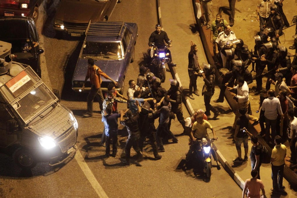 Riot policemen clash with protesters in Tahrir Square during a rally in support of Egypt's ousted president, Mohammed Mursi. Photo: Reuters