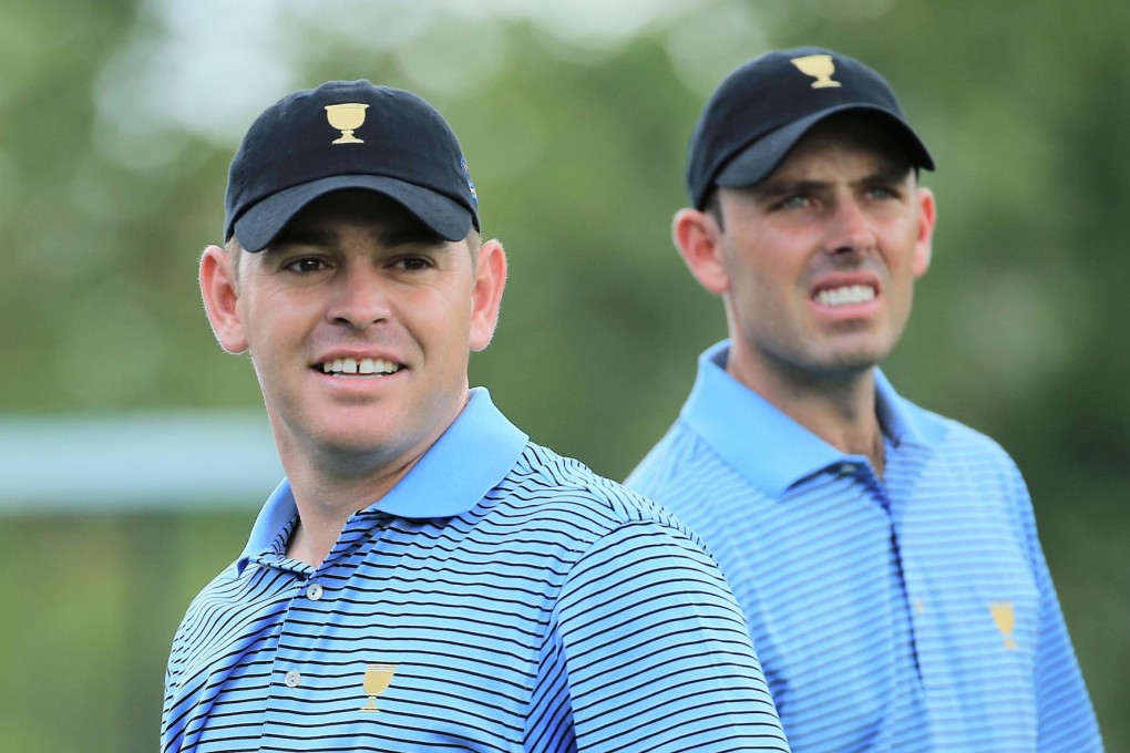 South Africans Charl Schwartzel and Louis Oosthuizen hide their close-cropped haircuts. Photo: AFP