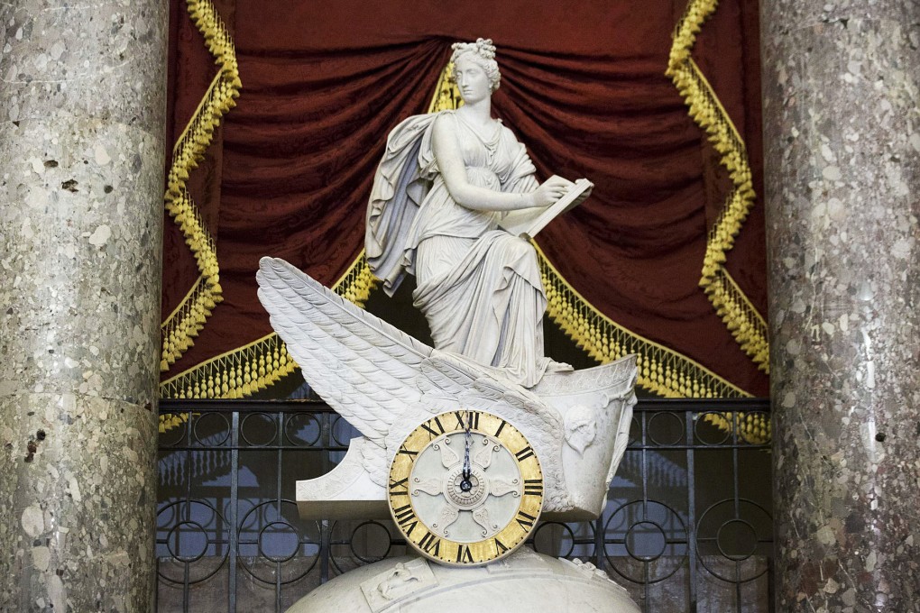 A clock strikes midnight in Washington as the shutdown takes effect. Photo: Bloomberg