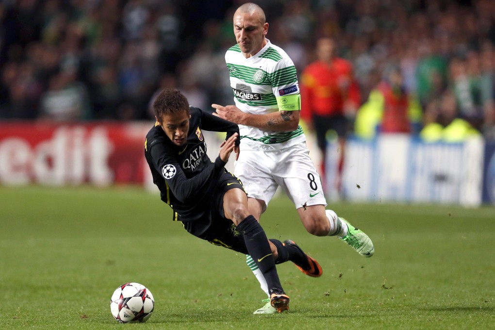Barcelona's Neymar is fouled by Celtic's Scott Brown. Photo: AFP