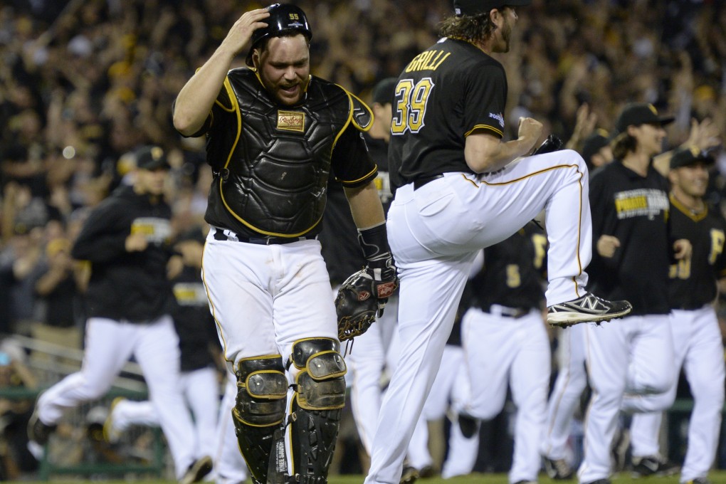 Pirates catcher Russell Martin (left) and relief pitcher Jason Grilli celebrate after getting the last out in the ninth inning. Photo: AP