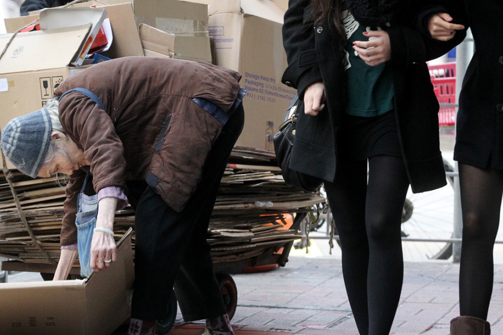 An old woman collects cardboard for cash in Causeway Bay. Photo: Felix Wong