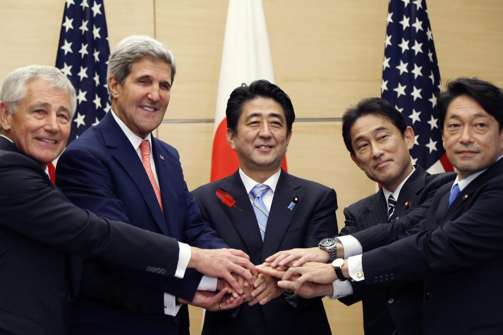Japanese PM Shinzo Abe (centre) with Chuck Hagel and John Kerry on his right and their Japanese counterparts on his left. Photo: EPA