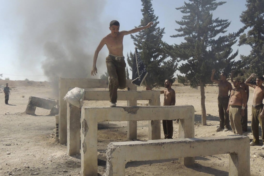 A recruit for the Western-backed Free Syrian Army tackles an obstacle course outside Damascus. Photo: Reuters